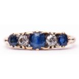 Antique sapphire and diamond ring featuring three circular shaped sapphires and two small