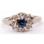 18ct white gold sapphire and diamond cluster ring, the central circular shaped sapphire raised