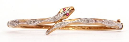 Modern 9ct gold diamond and ruby snake bracelet, hinged design, the serpent with 2 small ruby