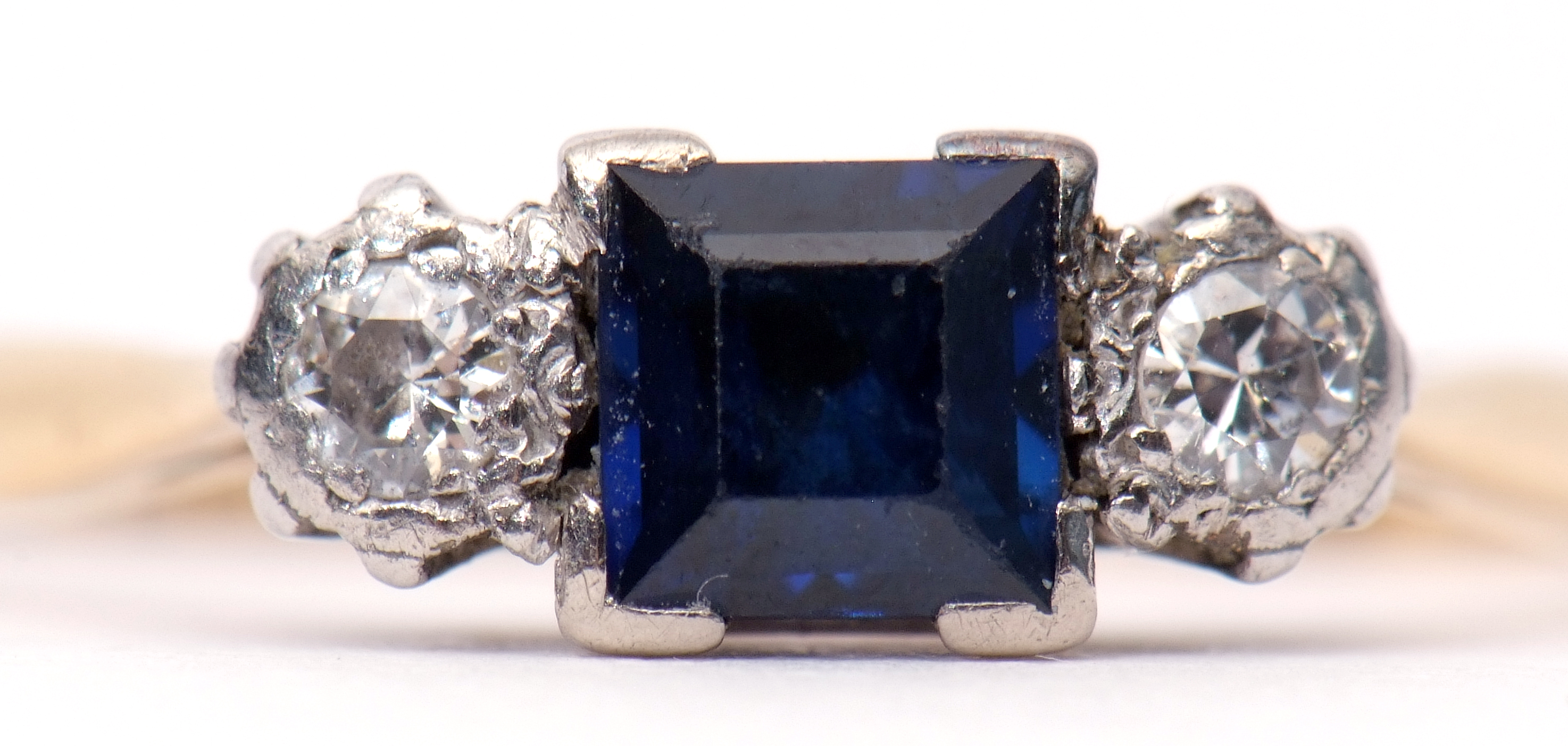 Art Deco sapphire and diamond ring, the square cut sapphire flanked by two small brilliant cut