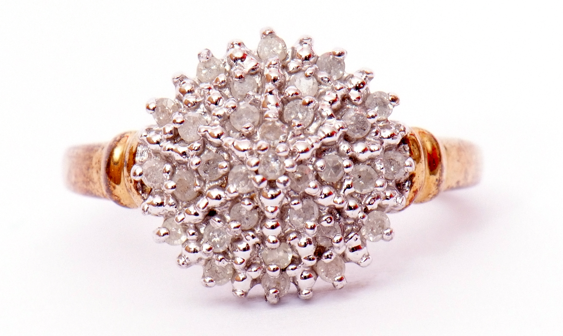 Modern diamond and cluster ring, a circular shaped panel set with small single cut diamonds, total