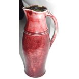 Rouge flambe style jug together with a small Art pottery jug, the largest 31cm high, indistinctly