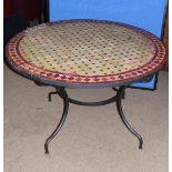 Modern Spanish mosaic tile top circular table on iron splayed feet, 120cm diam