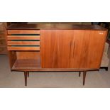 Mid-century teak cabinet with three sliding doors, the left hand side fitted with four drawers,