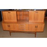 Mid-century teak G-plan sideboard, three drawers to centre, flanked by two twin door cupboards,