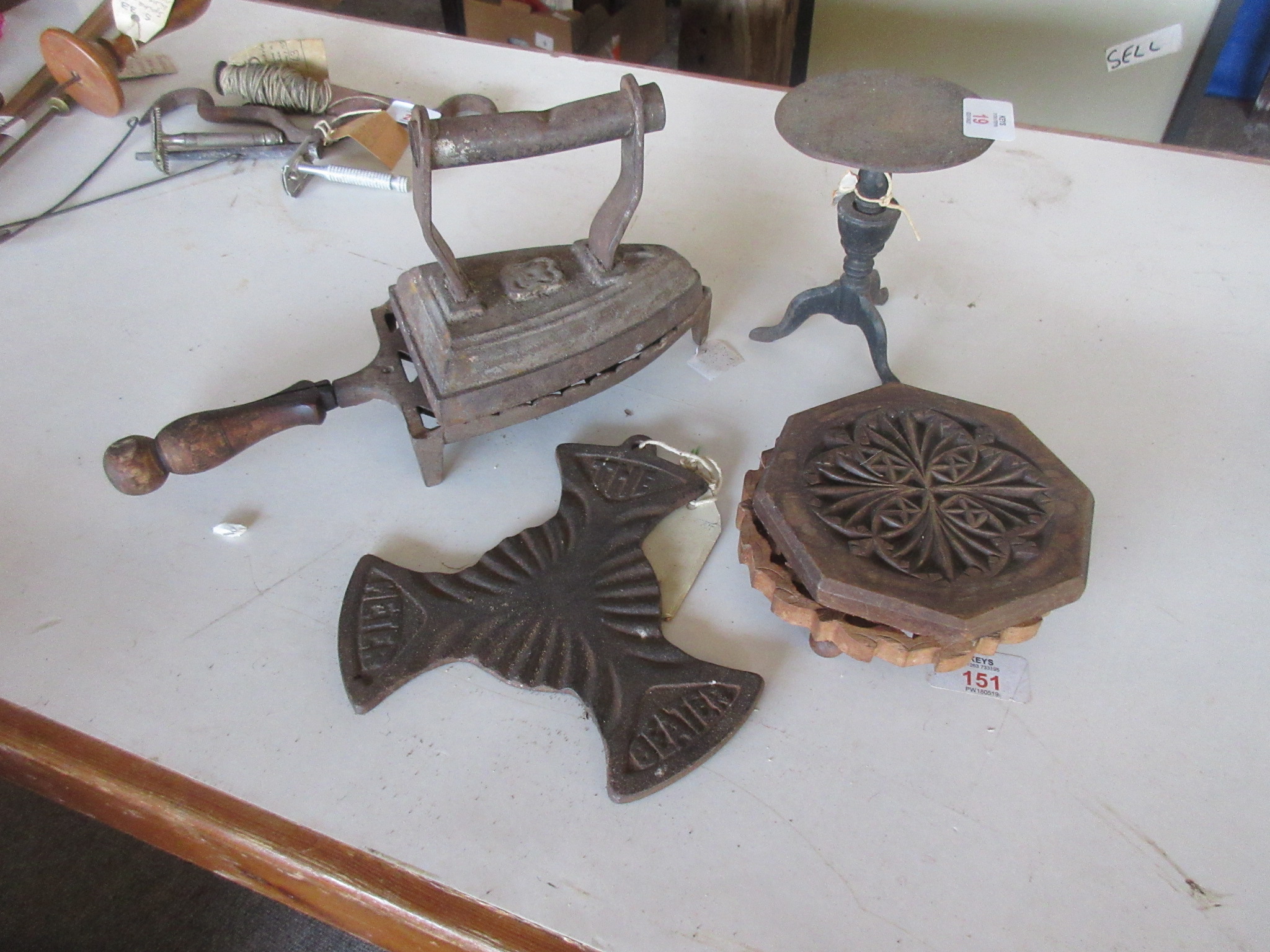 VINTAGE FLAT IRON TOGETHER WITH A QUANTITY OF VARIOUS TRIVETS, TWO WOODEN CARVED AND TWO METAL