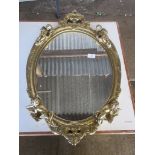 GOOD QUALITY OVAL MIRROR, THE GILT FRAME MOULDED WITH FIGURES OF CHERUBS AND OTHER DECORATION, TOTAL