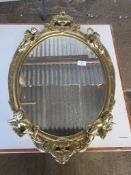 GOOD QUALITY OVAL MIRROR, THE GILT FRAME MOULDED WITH FIGURES OF CHERUBS AND OTHER DECORATION, TOTAL