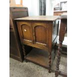 MID-20TH CENTURY OAK FRAMED SIDE CUPBOARD WITH TWO CUPBOARD DOORS OVER OPEN SHELF WITH BARLEY