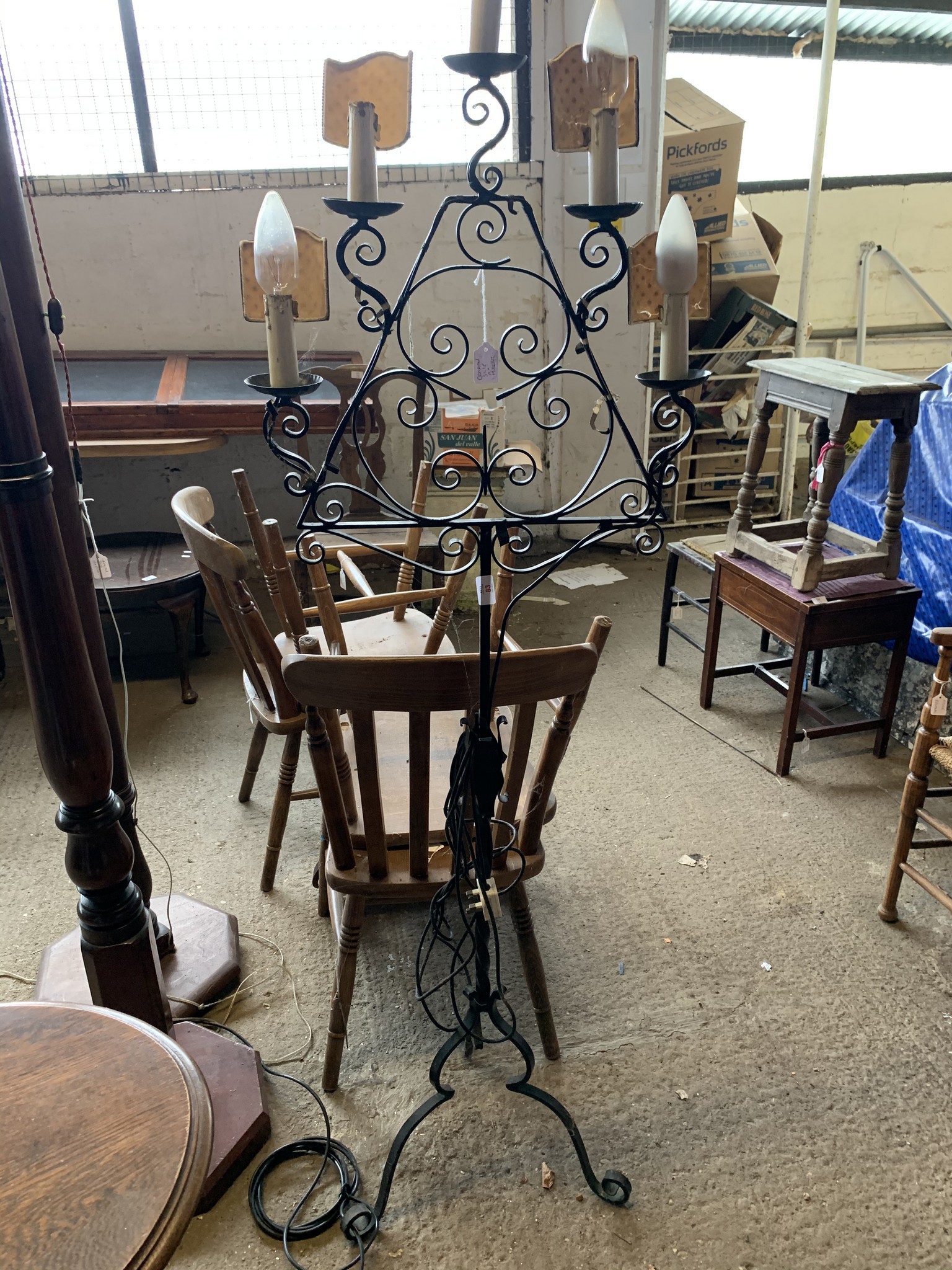 WROUGHT IRON LAMP STAND RAISED ON TRIPOD LEGS WITH FIVE CANDLEHOLDERS, HEIGHT APPROX 56CM