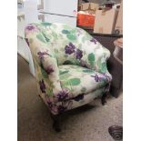 EDWARDIAN FLORAL UPHOLSTERED TUB CHAIR WITH CABRIOLE FRONT LEGS RAISED ON BRASS CASTERS