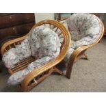 TWO BAMBOO FRAMED ARMCHAIRS WITH FLORAL UPHOLSTERED CUSHIONS