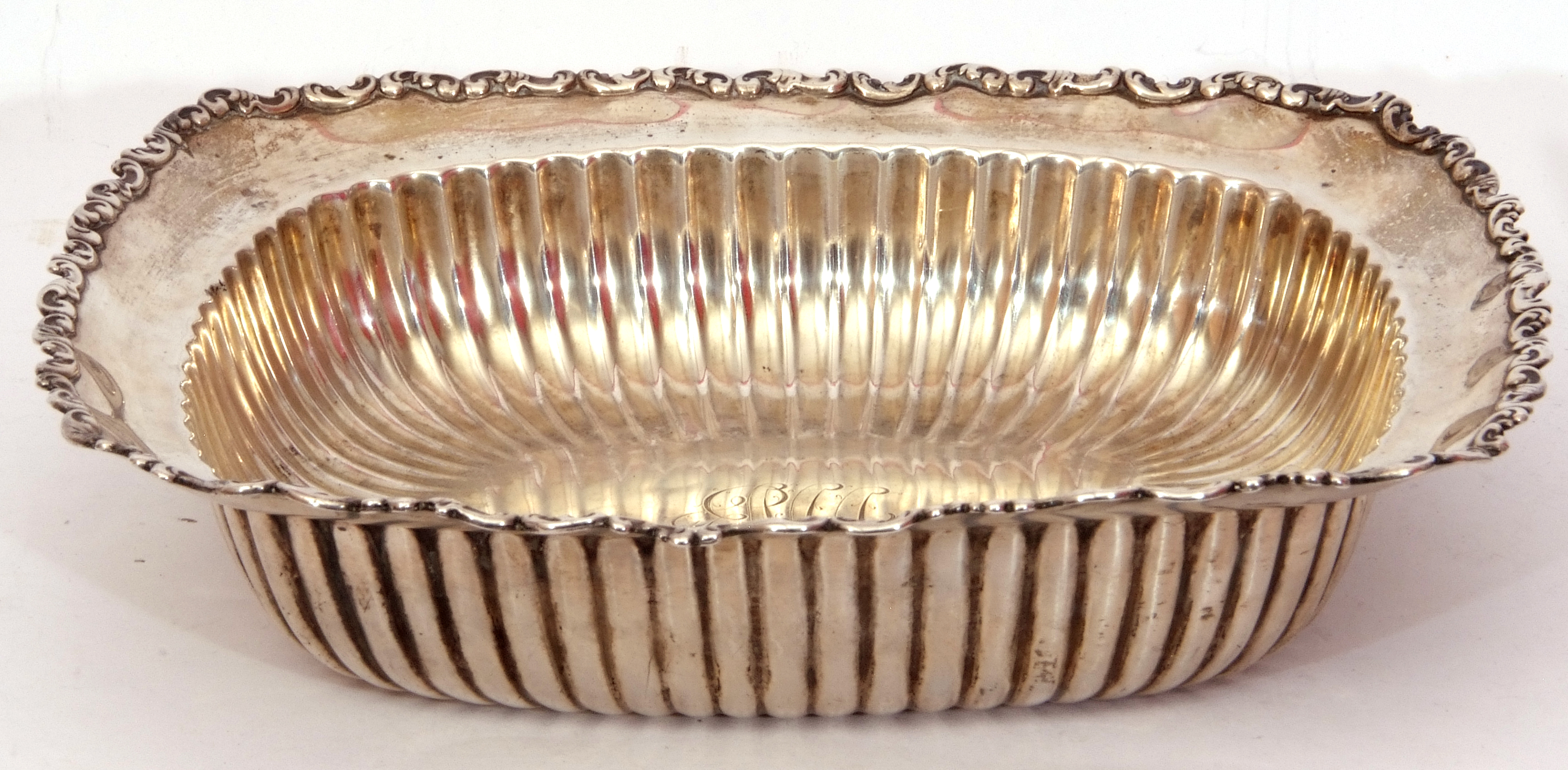 Late 19th century white metal shallow table dish of rectangular form, with scroll rim and ribbed