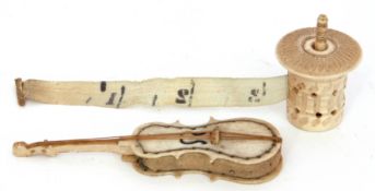 Mixed Lot: Antique ivory tape measure, 4cm tall, together with a cello formed pin cushion, circa