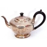 George V silver tea pot of compressed circular form on a spreading foot, beaded rim decoration,