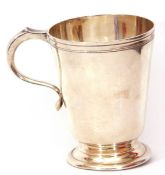 Mid-20th century silver mug, of polished tapering circular form, applied with scroll capped handle
