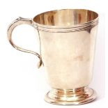 Mid-20th century silver mug, of polished tapering circular form, applied with scroll capped handle