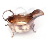 Early 20th century silver sauce/gravy boat of traditional helmet form, with decorative wavy rim,