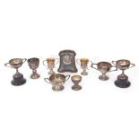 Mixed Lot: seven hallmarked silver small golf presentation trophies and socles, various dates and