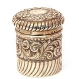 Late Victorian silver lidded canister of cylindrical form, embossed and wrythen decoration,