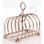 Late Victorian six slice toast rack, the wirework design with central carrying ring handle on a