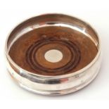 Elizabeth II silver wine coaster of plain polished circular form, treen base, 13cm diam, London