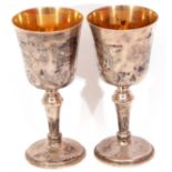 Pair of Elizabeth II silver goblets with inverted bell shaped bowls, gilt interiors on knopped stems