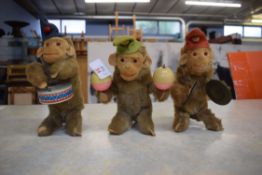 Group of three monkey band soft toy musicians including a drummer, cymbal player and castanet