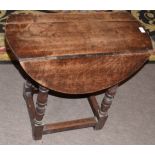 Small 19th century oak drop leaf occasional table on ring turned legs to a stretcher base, the top