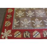 Large 20th century wool work wall hanging in heraldic style, the border featuring various shields,