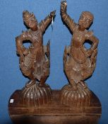 Pair of Tibetan carved hardwood figures of costumed dancers on fluted half-melon bases, 64cm tall (