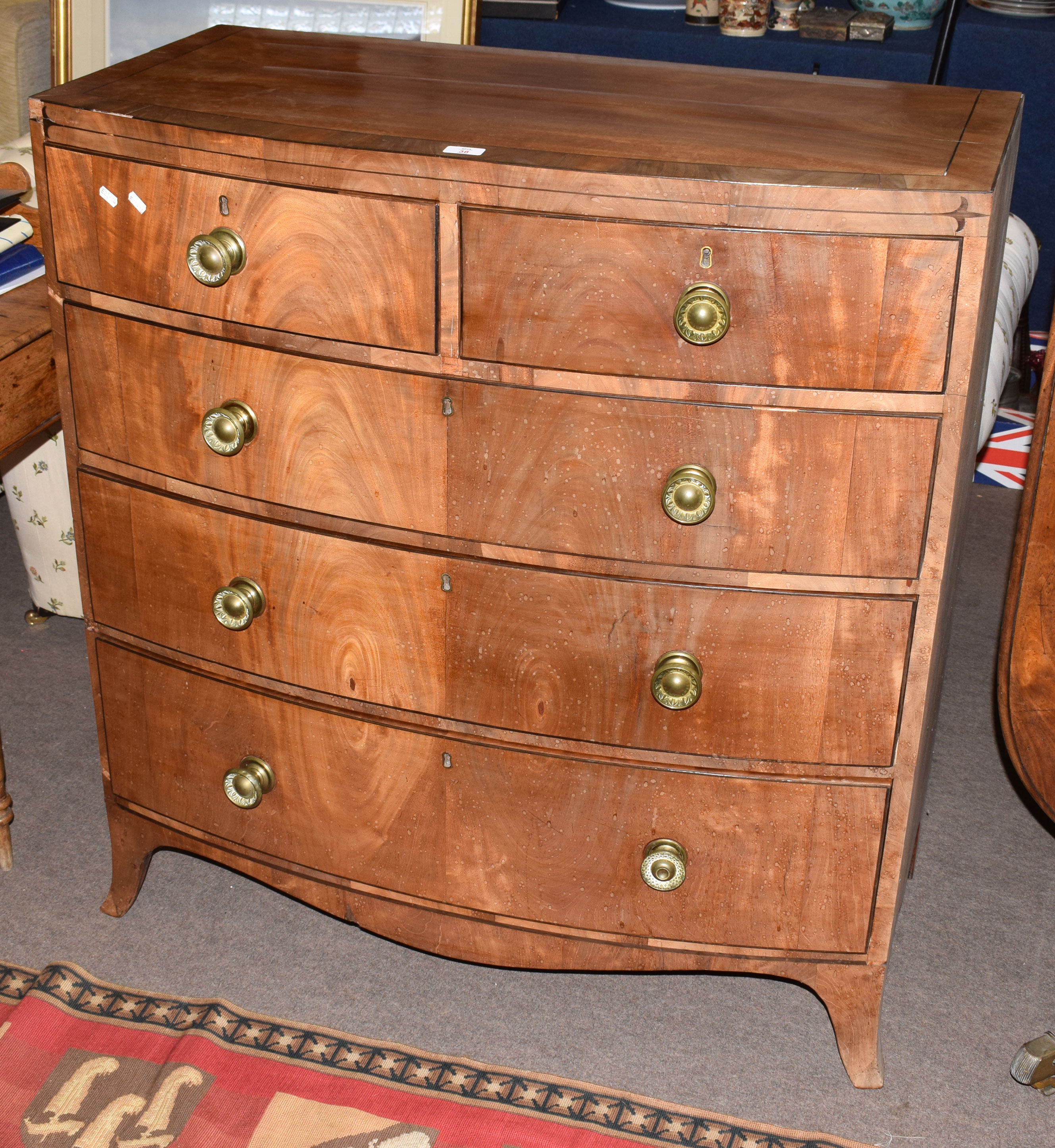Late Georgian cross-banded, mahogany veneered bow front chest of two and three drawers with embossed