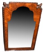 Mahogany wall mirror of arched form with shaped top, the two upper corners carved with acanthus leaf