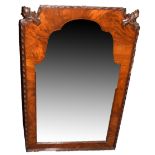 Mahogany wall mirror of arched form with shaped top, the two upper corners carved with acanthus leaf