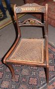 Set of four Regency simulated rosewood, cane seated and sabre leg dining chairs with carved and