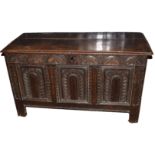 18th century polished and carved oak coffer having three arched carved panels below a lunette