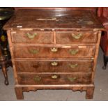 Early 18th century walnut veneered small chest of two and three drawers, having quartered veneered