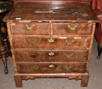 Early 18th century walnut veneered small chest of two and three drawers, having quartered veneered