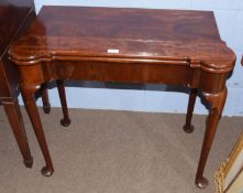 Georgian mahogany fold-top card table of shaped rectangular design, the folding top opening to