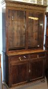 Early 20th century stained oak glazed top bookcase cabinet having two plain glass doors beneath a