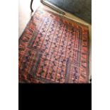 Early/mid-20th century Belouch style wool rug with repeating geometric patterns in blue to a red