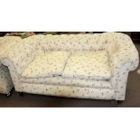 Matched pair of late Victorian Chesterfield sofas both upholstered in matching floral button back (