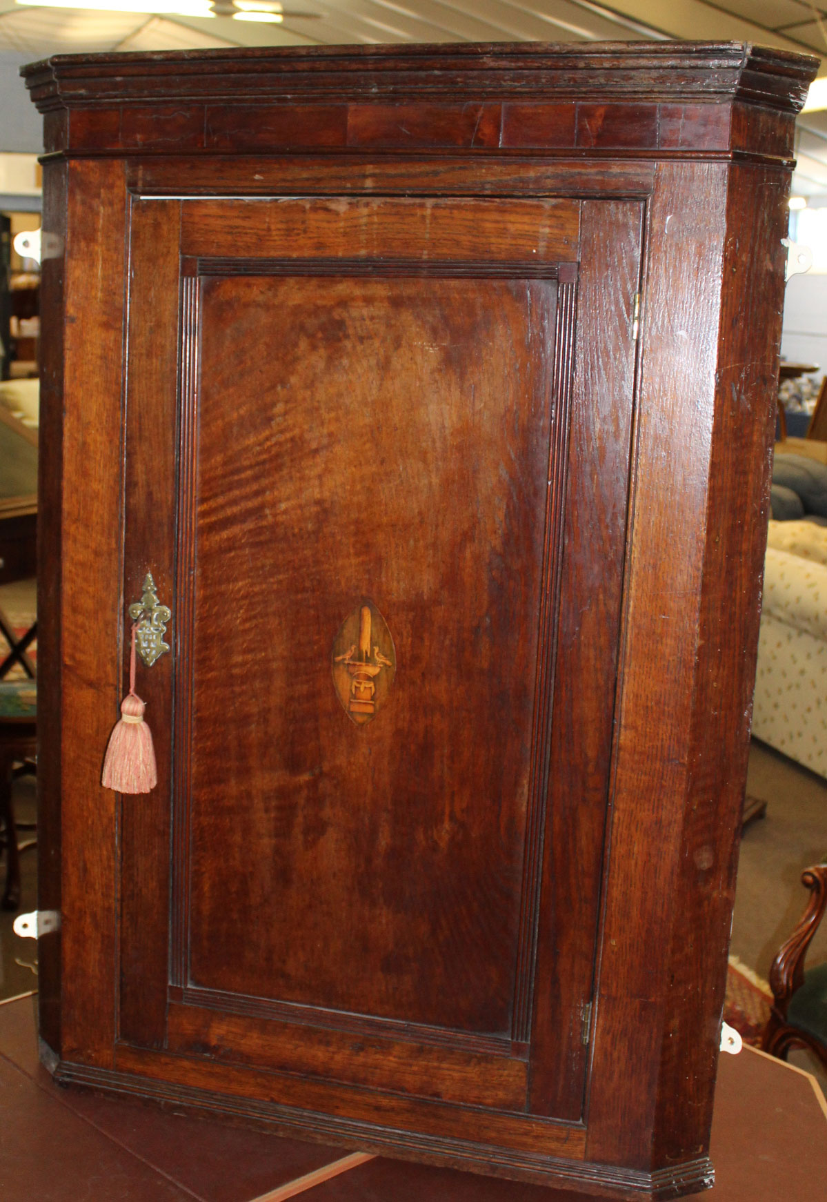 18th century oak wall mounting corner cupboard, panelled door inlaid in the centre with birds on a