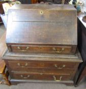 Oak bureau, fall front over a fitted interior with three drawers below, 18th century and later,