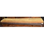 Long and low oak foot stool made from period materials, having foliate carved side friezes,