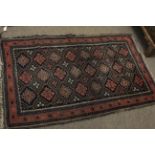 Small Caucasian rug with geometric patterns in rust and blue within five borders, 36cm x 58cm