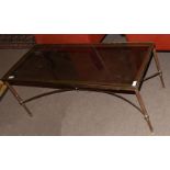 Second or third quarter of 20th century brass framed and smoke glass top coffee table with four