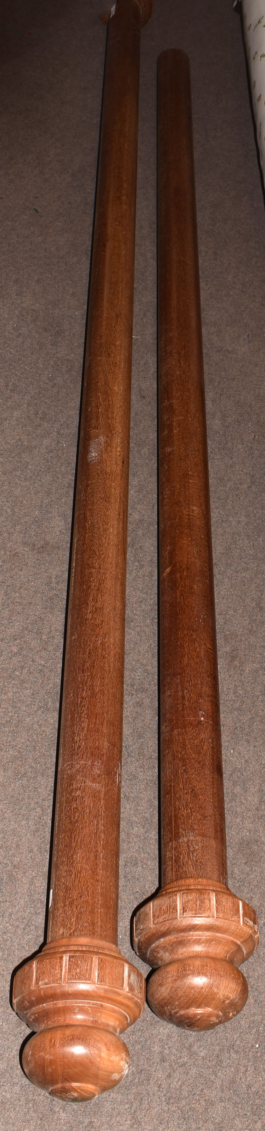 Two large mahogany curtain poles, with turned end finials, 280cm long, the other with one only