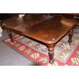 Mid-Victorian mahogany extending dining table of rounded-end rectangular form and inset with one