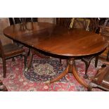 Reproduction mahogany twin pedestal dining table with one extra leaf supported on two vase turned